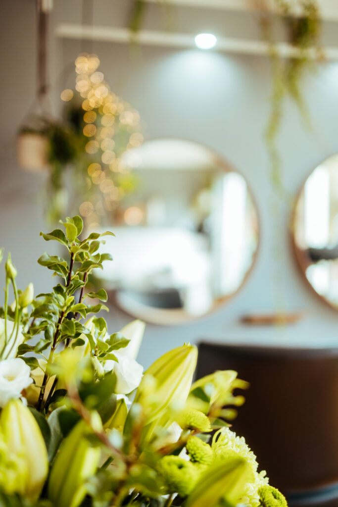 Floral arrangement and round mirrors in the salon interior